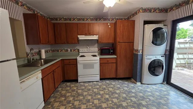 a utility room with sink dryer and washer