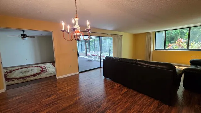 a living room with hard wood floors and a window