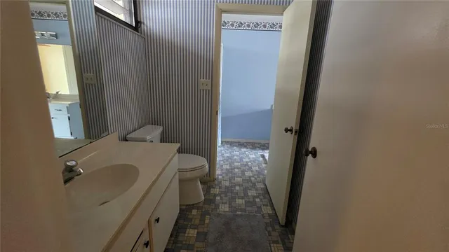 a bathroom with a sink and toilet