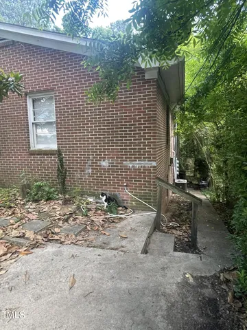 a backyard of a house with table and chairs