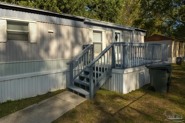 a view of a house with a wooden deck