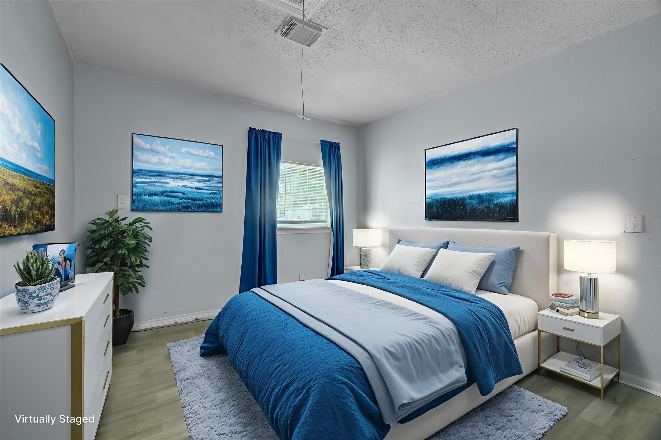 418 Azalea Street Lake Jackson, TX 77566 - Photo 19 of 34 a bedroom with bed and paintings on the wall