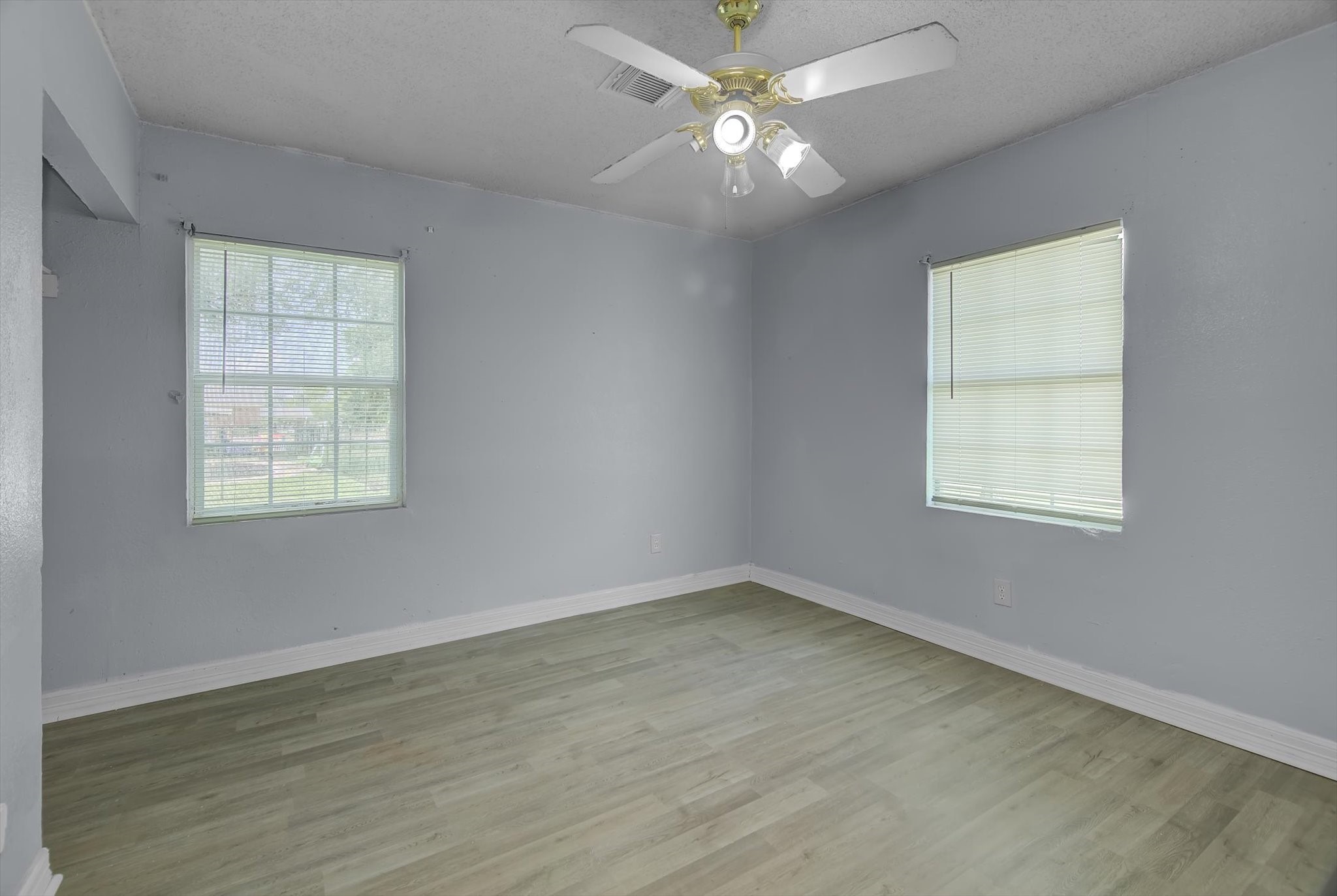 418 Azalea Street Lake Jackson, TX 77566 - Photo 22 of 34 Bright and inviting bedroom with ample natural light, neutral tones, and a ceiling fan for comfort.