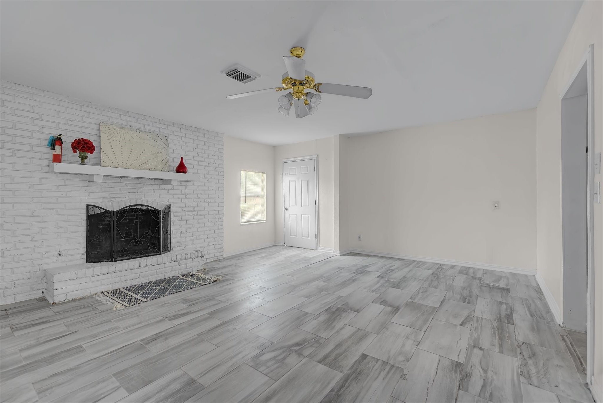 418 Azalea Street Lake Jackson, TX 77566 - Photo 9 of 34 a view of empty room with fireplace and wooden floor
