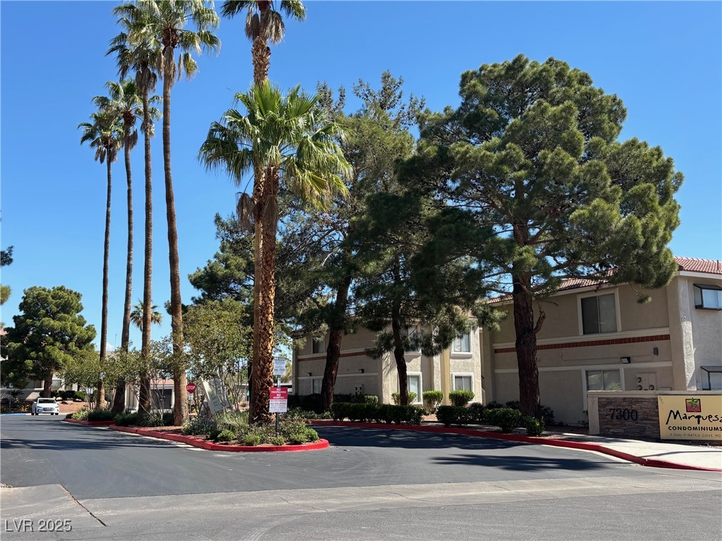 7300 West Pirates Cove Road, Unit 2054 Las Vegas, NV 89145 - Photo 16 of 16 View of asphalt road with curbs, sidewalks, and traffic signs