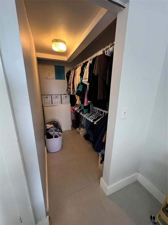 9235 A Lagoon Place, Unit 310 Davie, FL 33324 - Photo 16 of 32 a view of walk in closet with clothes and shoes