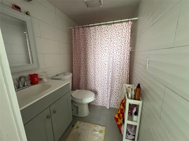 a bathroom with a sink toilet and a mirror
