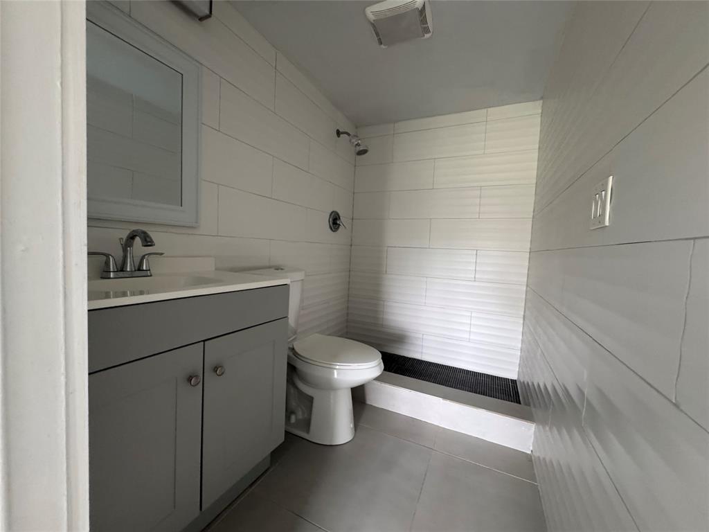 9235 A Lagoon Place, Unit 310 Davie, FL 33324 - Photo 18 of 32 a bathroom with a sink toilet and shower
