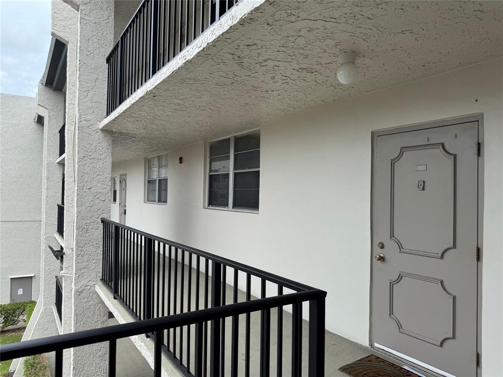 9235 A Lagoon Place, Unit 310 Davie, FL 33324 - Photo 25 of 32 a view of a hallway with wooden floor and staircase