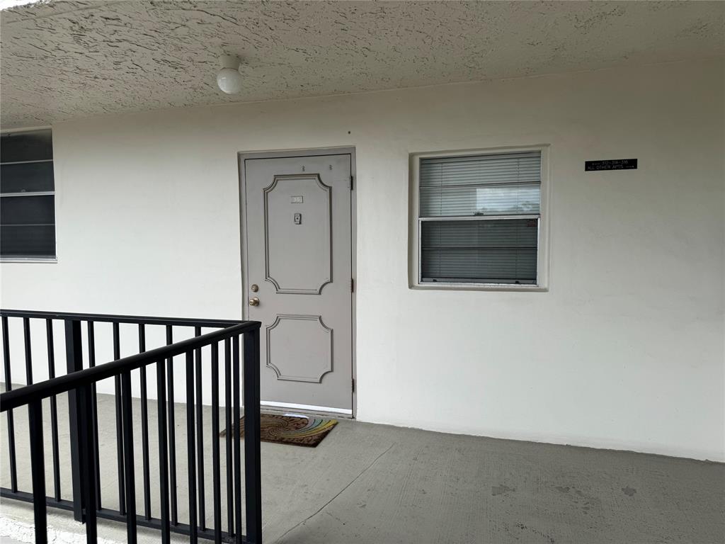 9235 A Lagoon Place, Unit 310 Davie, FL 33324 - Photo 26 of 32 a view of a hallway with wooden floor