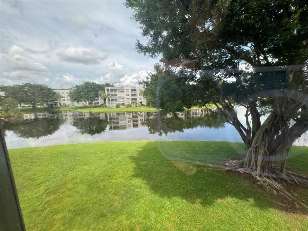 9235 A Lagoon Place, Unit 310 Davie, FL 33324 - Photo 27 of 32 a view of a lake with houses in the back