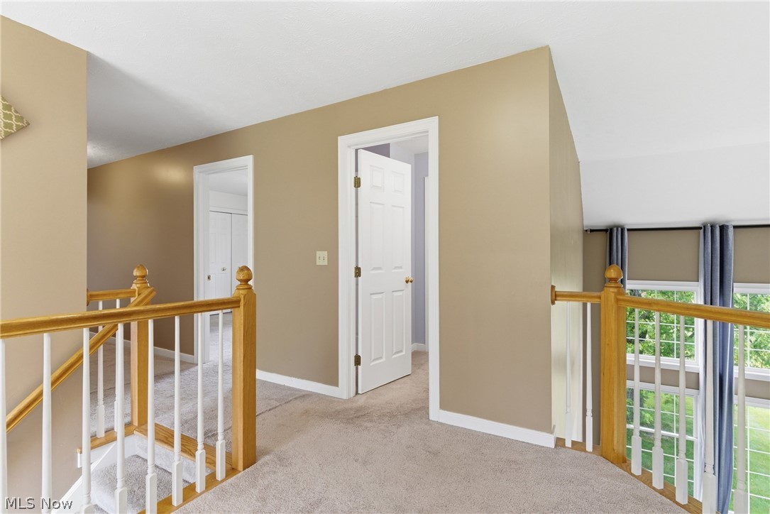 11678 Dunham Road Northfield, OH 44067 - Photo 17 of 38 Upper-level landing featuring carpeted flooring and light tan wall paint