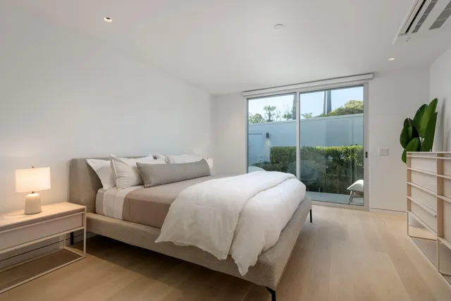 a bedroom with a large bed and a large window