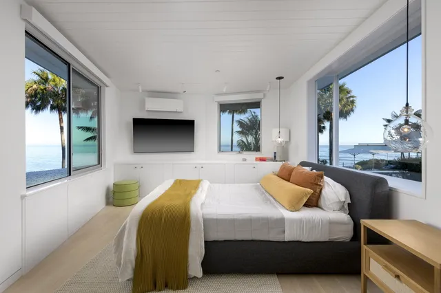 a bedroom with furniture and a large window