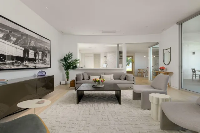 a living room with furniture and a large mirror