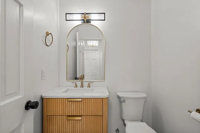 a bathroom with a sink toilet and vanity
