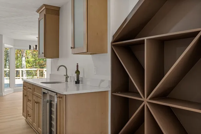 a kitchen with a sink a refrigerator and window