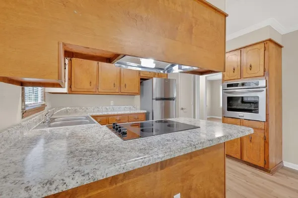a kitchen with stainless steel appliances granite countertop a sink and a stove