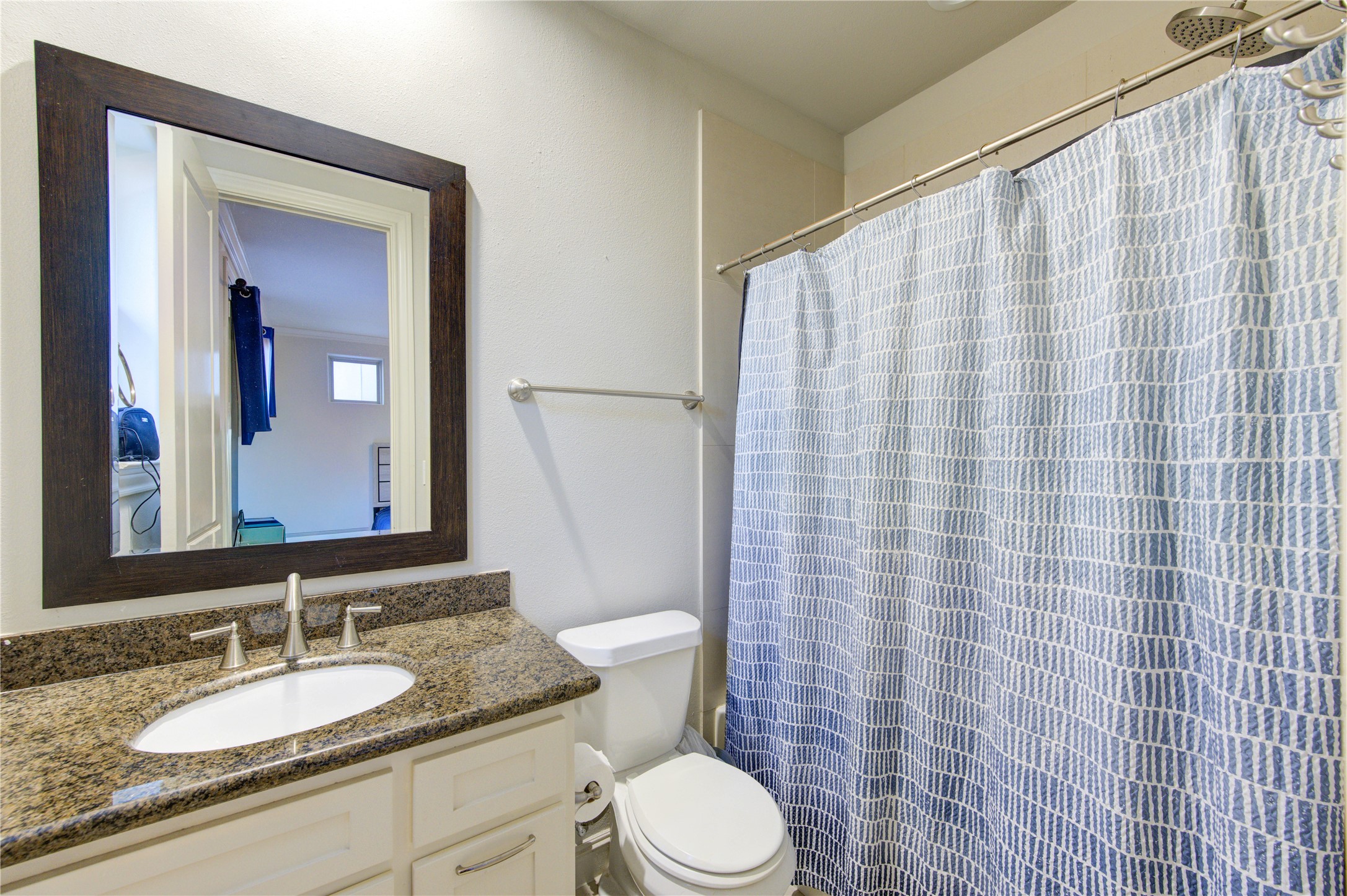 411 West 17th Street, Unit B Houston, TX 77008 - Photo 40 of 50 a bathroom with a granite countertop sink mirror vanity and toilet