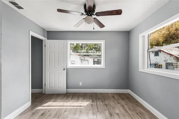wooden floor in an empty room with a window