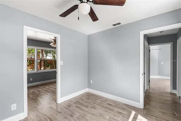 a view of an empty room and wooden floor