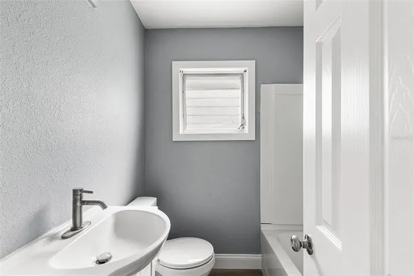 a white toilet sitting next to a bathroom sink