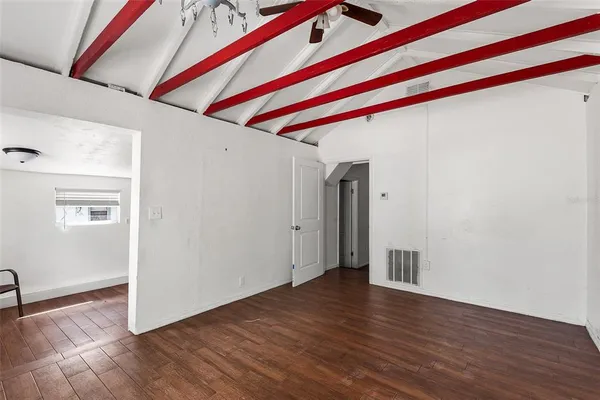 a view of a room with wooden floor