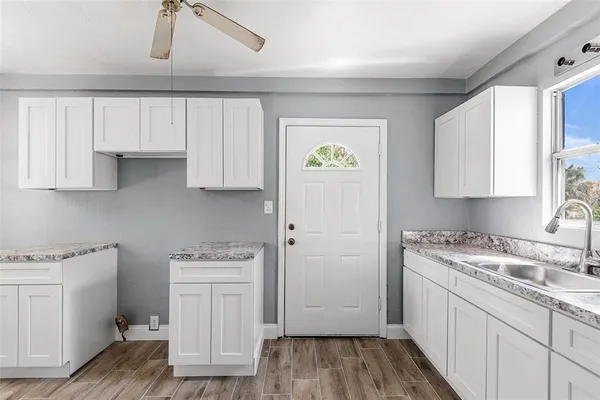 a kitchen with a stove a sink and a refrigerator