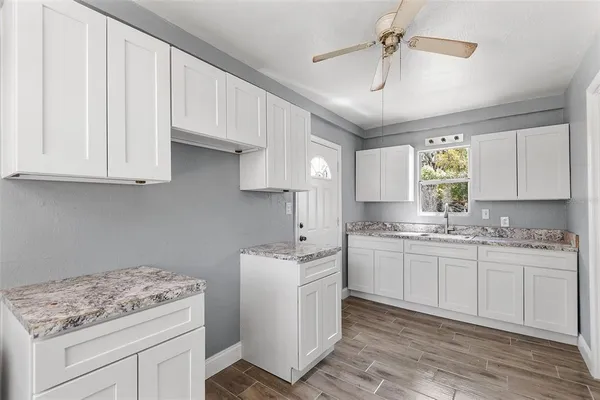 a kitchen with a sink stove and cabinets