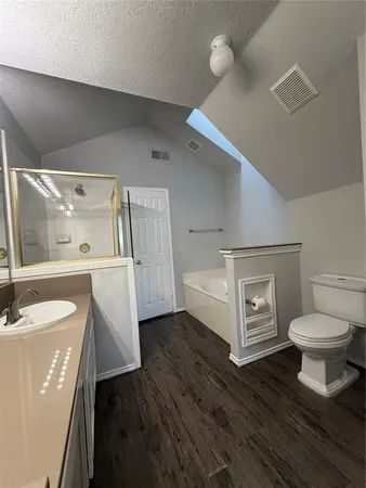 a bathroom with a sink toilet and shower