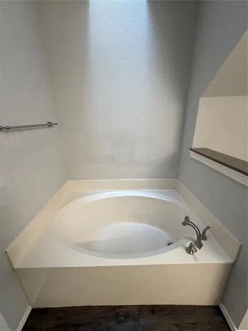 a white bath tub sitting in a bathroom