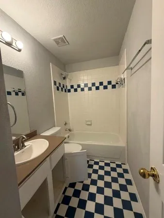 a bathroom with a double vanity sink toilet and shower