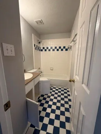 a bathroom with a black and white checkered floor