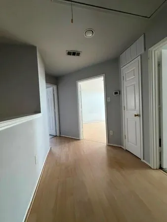a view of a livingroom with an empty space and a window