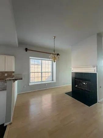 a living room with a fireplace and a window