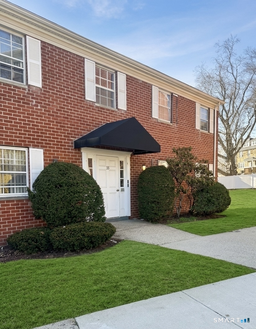 50 Greenhouse Road, Unit 33D Bridgeport, CT 06606 - Photo 1 of 1 a front view of a house with a garden