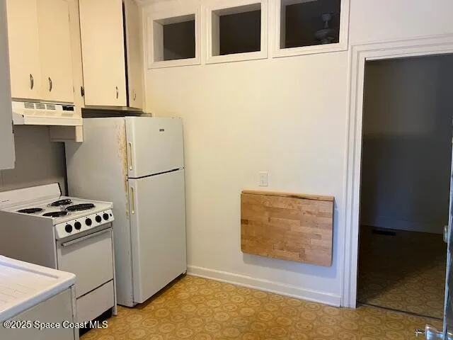 a view of kitchen with stainless steel appliances refrigerator and stove