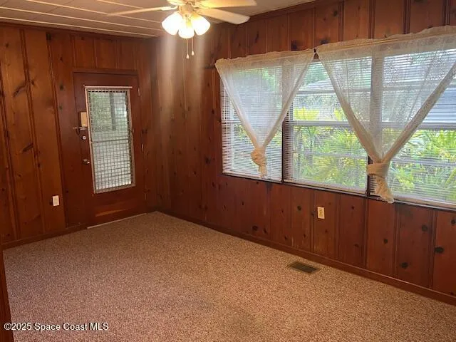 an empty room with windows and outdoor view