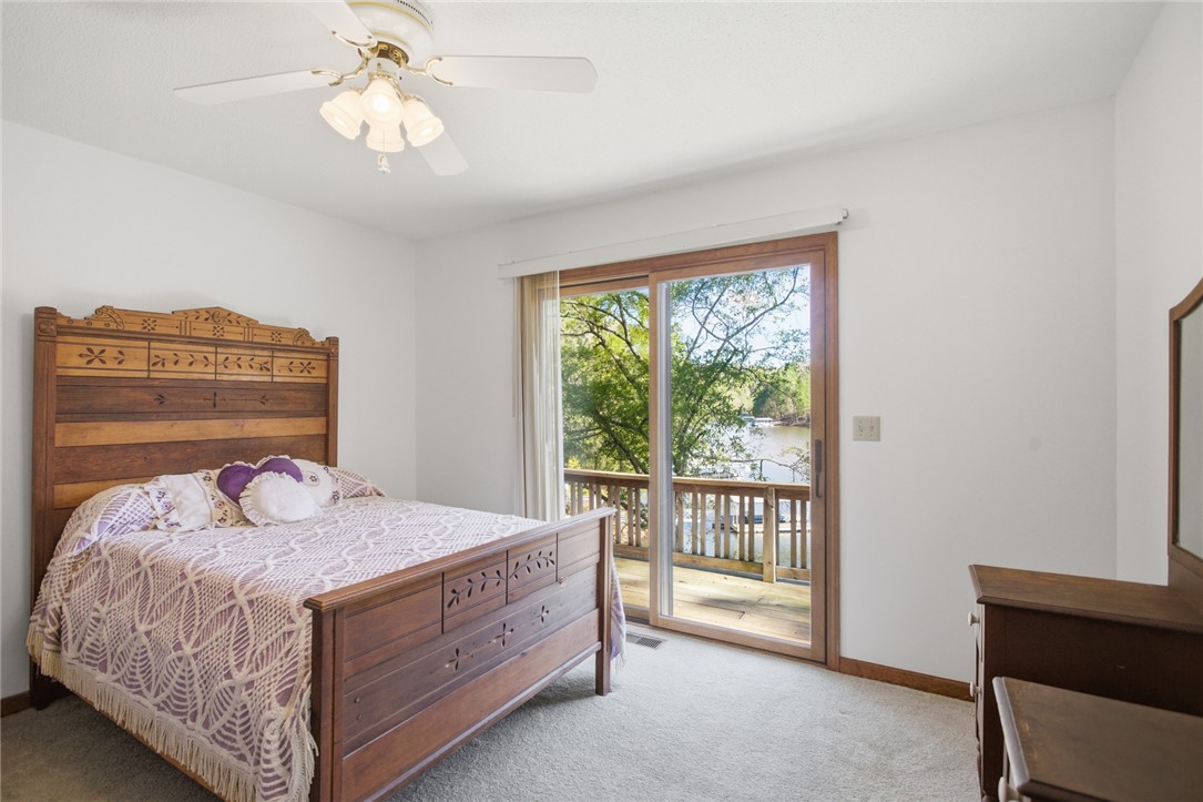 120 Farris Sandra Road West Union, SC 29696 - Photo 17 of 50 This serene bedroom offers a private deck with expansive waterfront views, perfect for peaceful mornings.