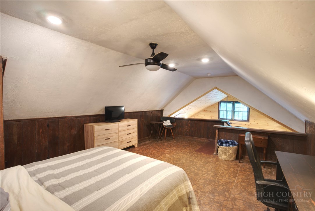 9440 Blackberry Road Lenoir, NC 28645 - Photo 19 of 30 a bedroom with a bed and a chandelier
