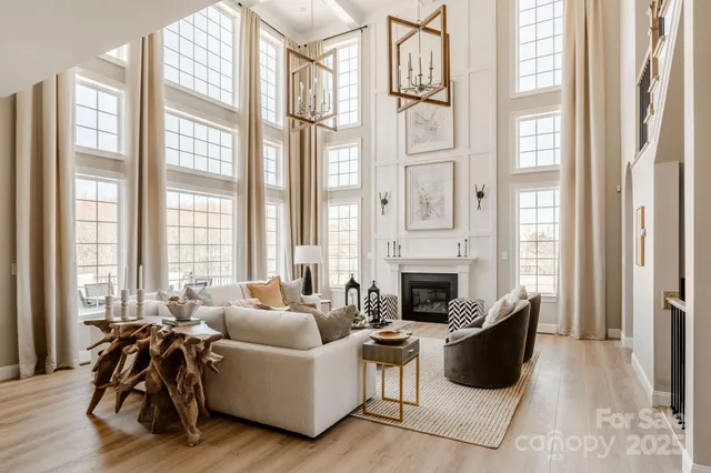 a living room with furniture and large windows