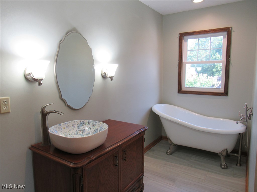 1120 Vincent Road Southeast North Canton, OH 44720 - Photo 23 of 50 Master Bathroom featuring Custom vanity, Beautiful Bowl, and a clawfoot bathtub