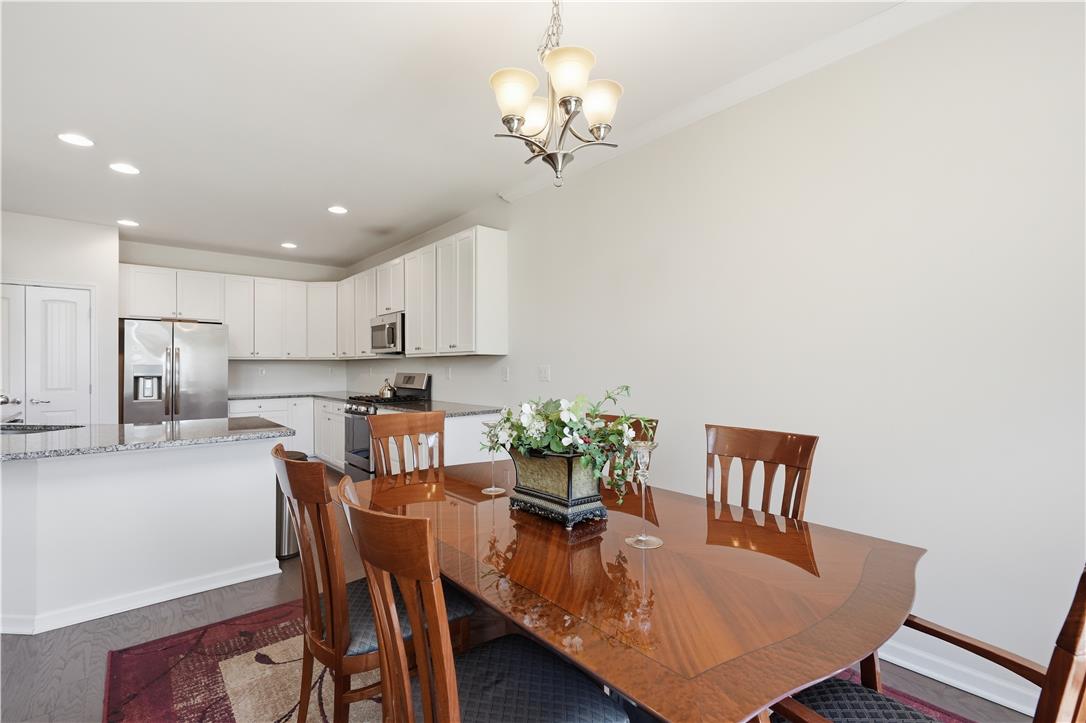 4120 Eveningstar Road Emmaus, PA 18049 - Photo 21 of 62 An open-concept living space highlights a seamless connection between the dining area and kitchen.