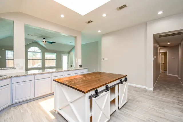 a bathroom with a sink a vanity and a large mirror