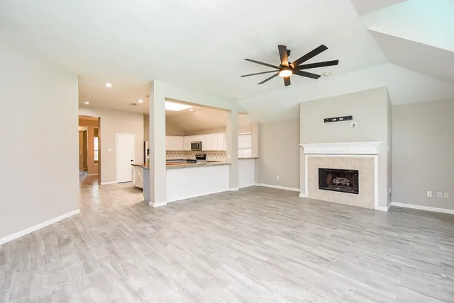 a view of a kitchen with a sink and a ceiling fan