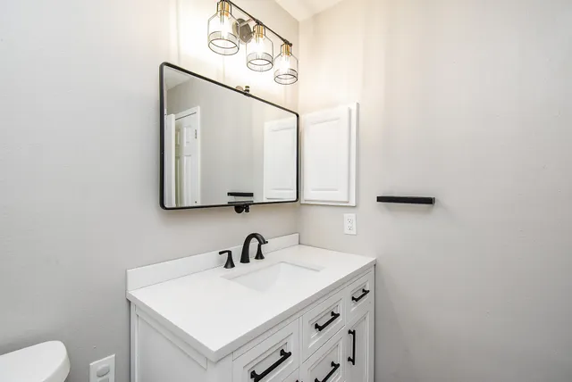 a bathroom with a sink and a mirror