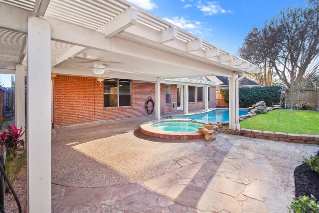 a view of a swimming pool with a patio
