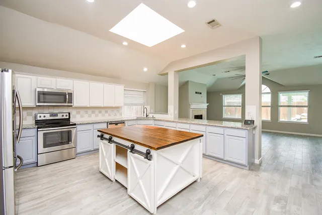 a kitchen with stainless steel appliances granite countertop a stove and a sink