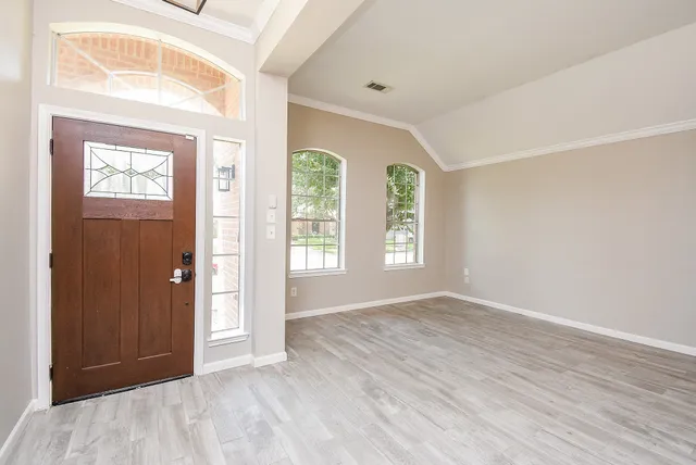 an empty room with windows and closet
