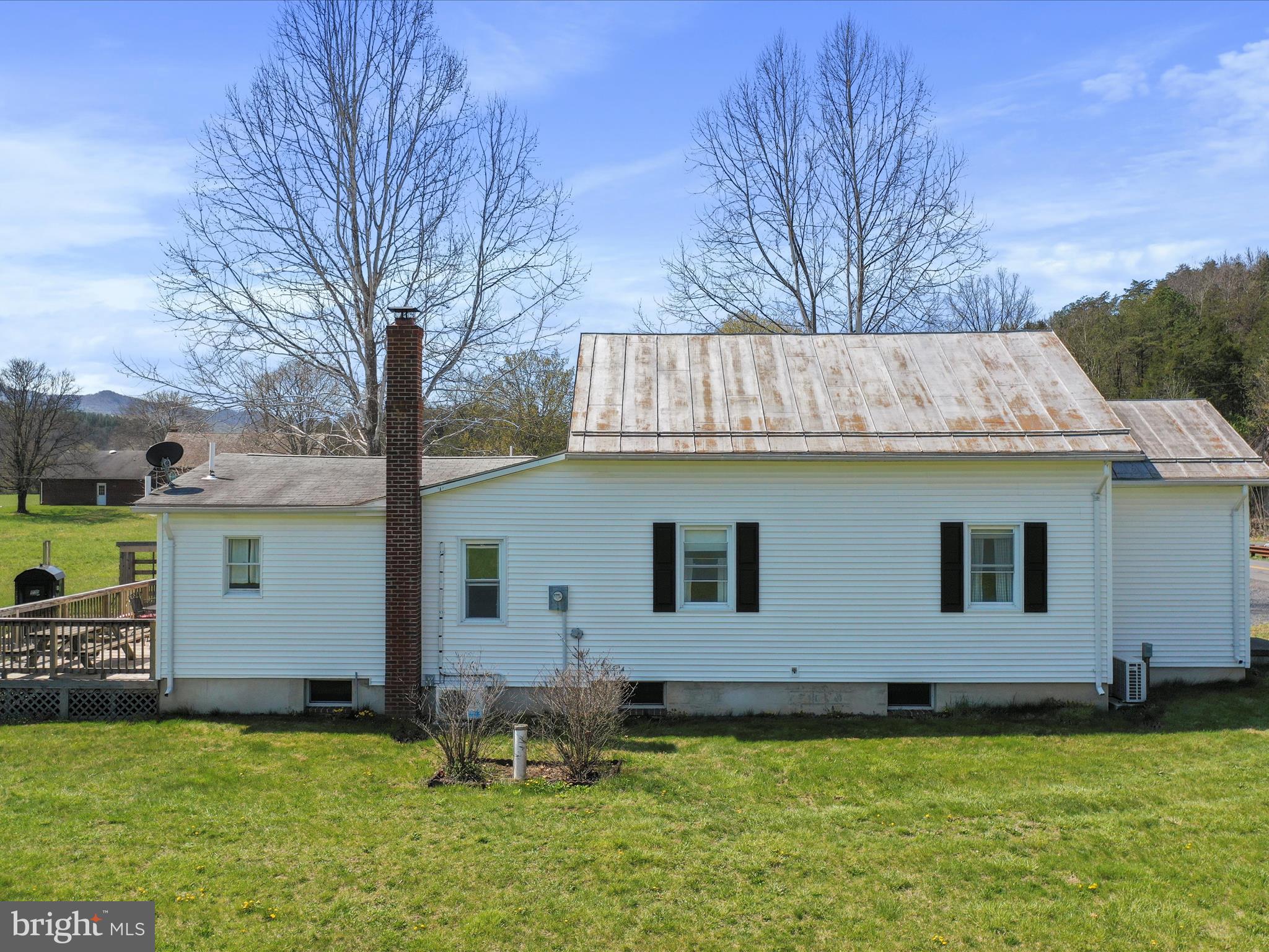 8610 Fort Valley Road Fort Valley, VA 22652 - Photo 11 of 61 a view of a backyard with table and chairs and wooden fence